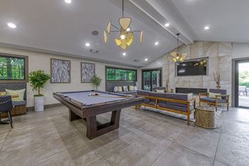 a game room with a pool table and a television